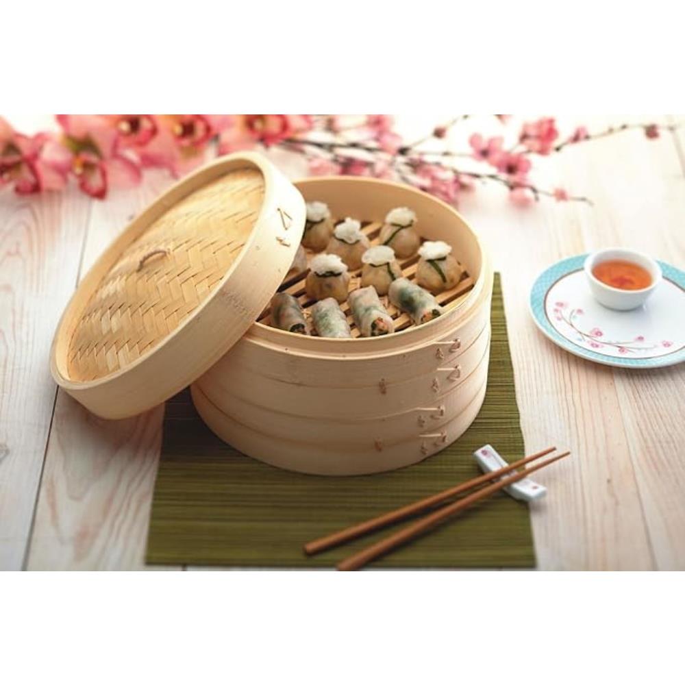 Wooden steamer basket with dumplings on a wooden table with cherry blossoms in the background