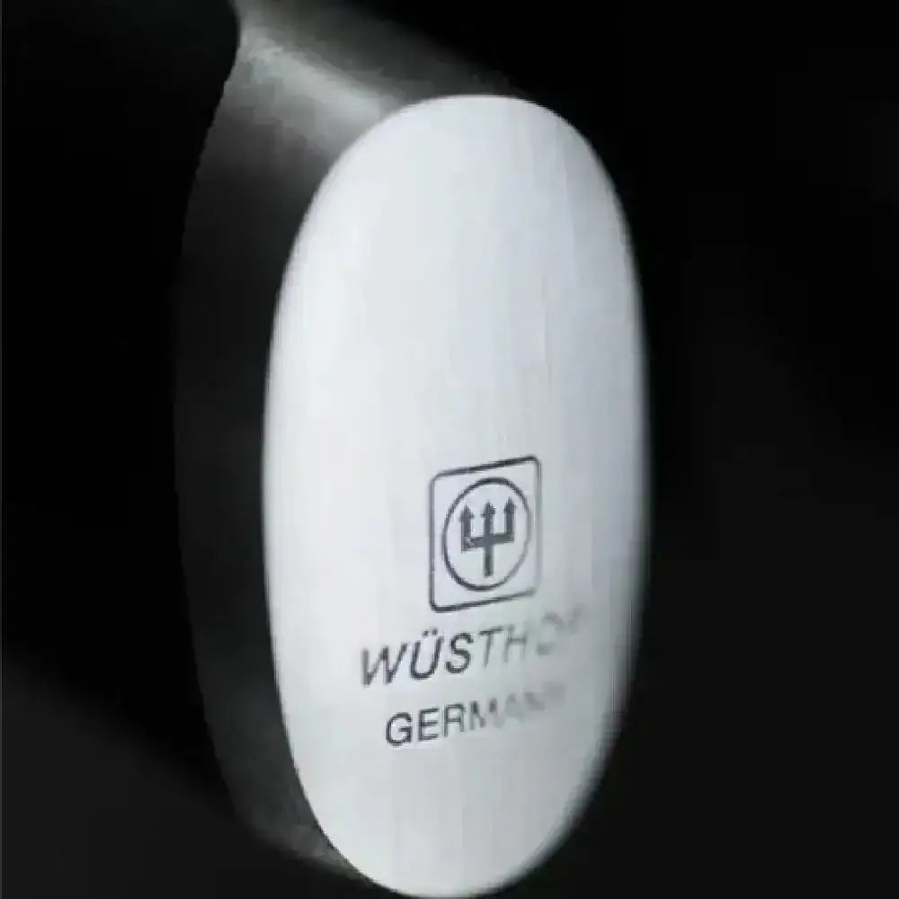 Close-up of a Wüsthof knife handle with brand logo on a black background
