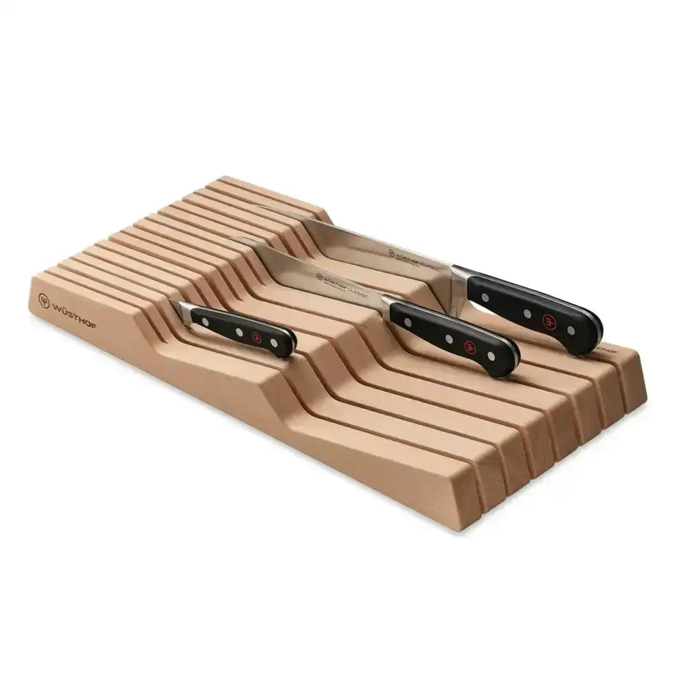 Wooden knife block with three knives on a white background
