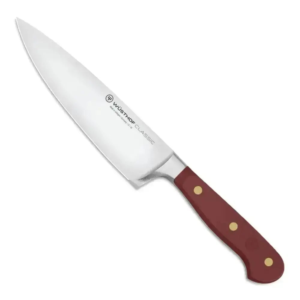 Chef's knife with a red handle on a white background