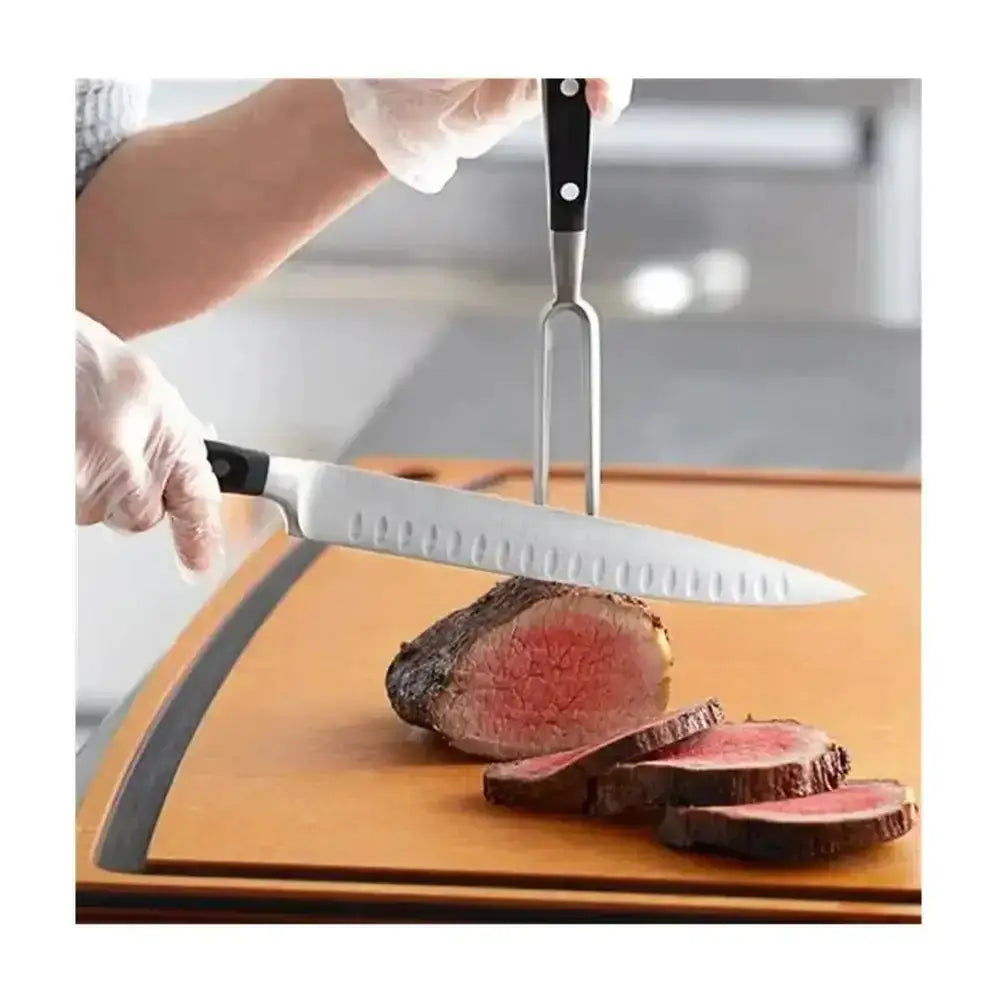 Person cutting a piece of beef on a wooden board with a knife and fork.
