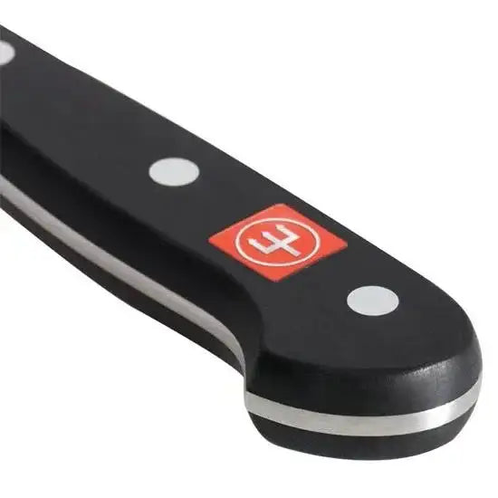 Close-up of a black knife handle with a red and white logo on a white background