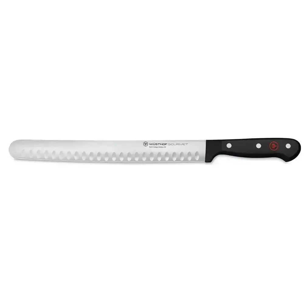 Long bread knife with a black handle on a white background