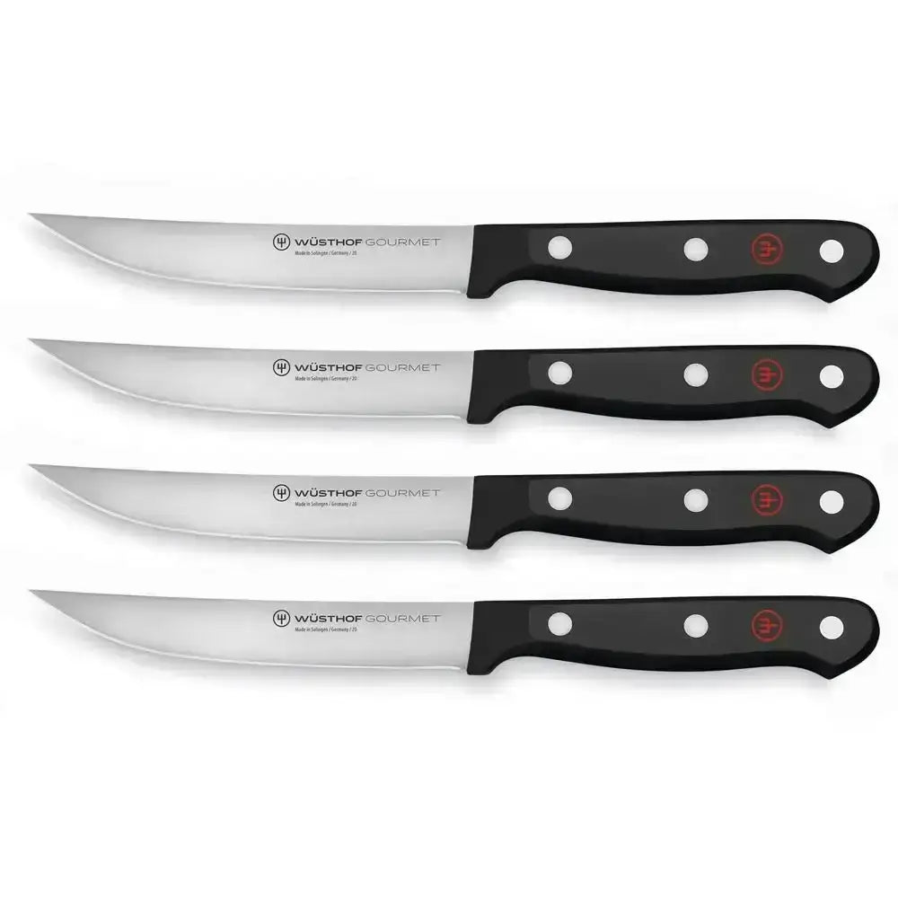 Set of five Wüsthof Gourmet steak knives on a white background
