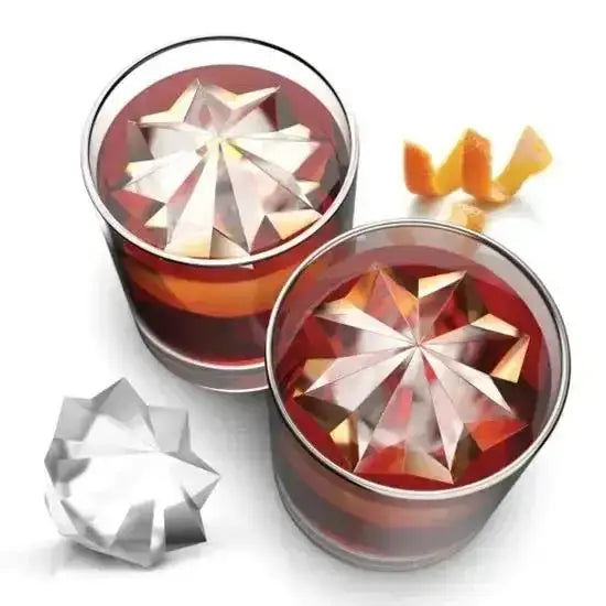 Two glass tumblers with geometric ice cubes and orange slices on a white background