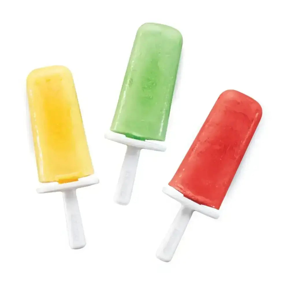 Three colorful homemade popsicles on white background, yellow, green, and red frozen treats.