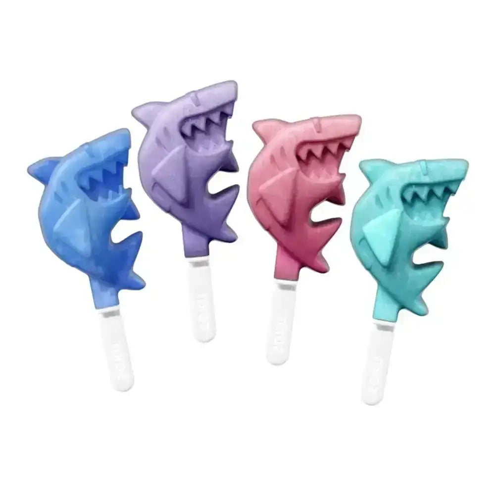 Four shark-shaped ice cream sticks in blue, purple, pink, and green on a white background.