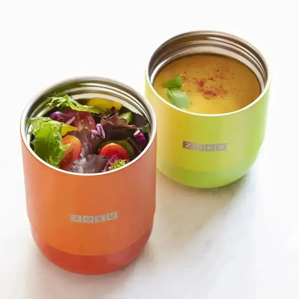 Two colorful Zoku containers with food on a white background