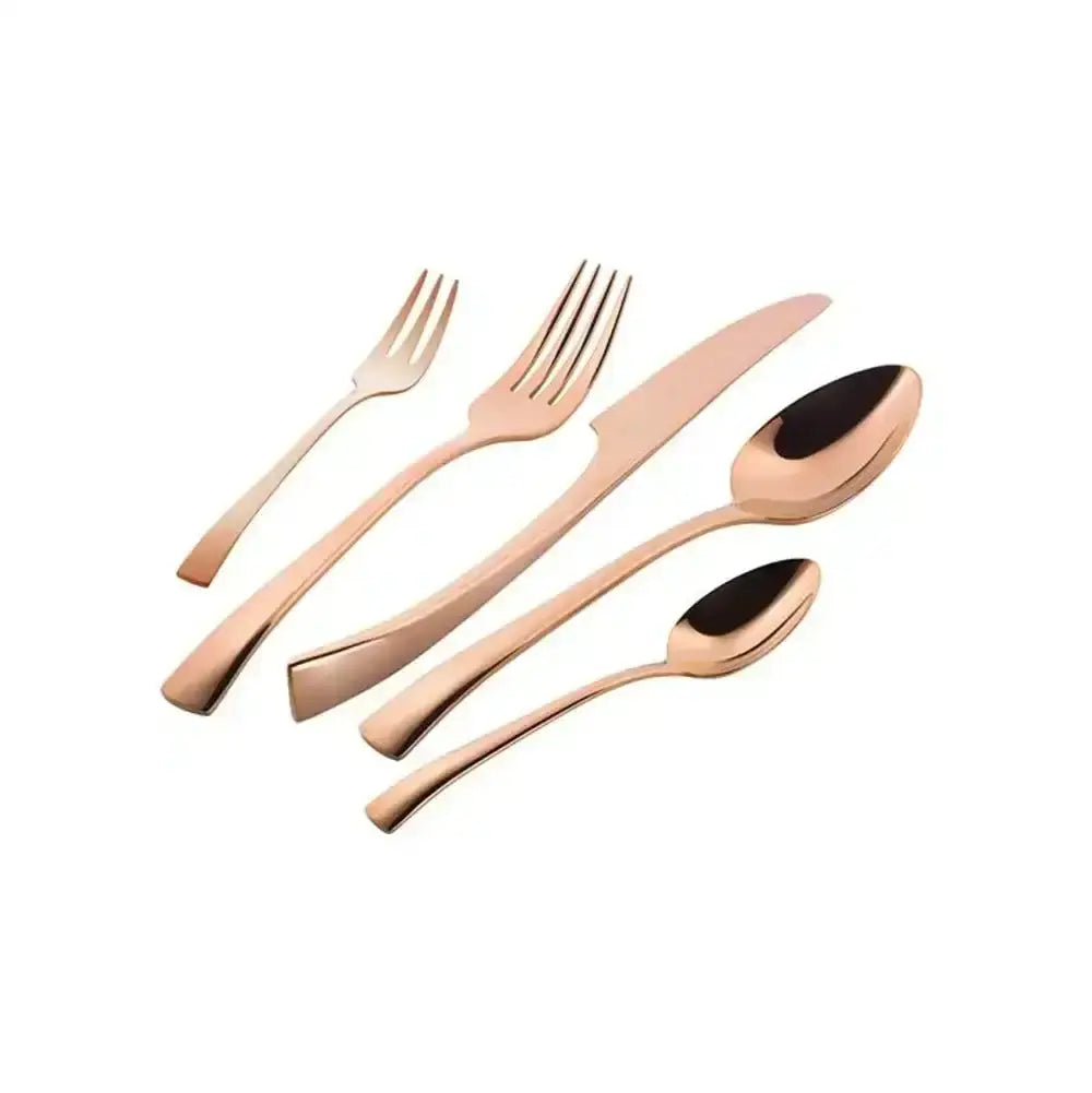 Set of rose gold flatware on a white background
