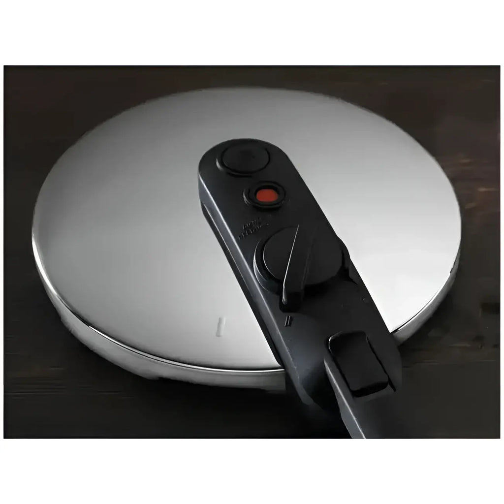 Close-up of a pressure cooker lid with a release valve on a wooden surface