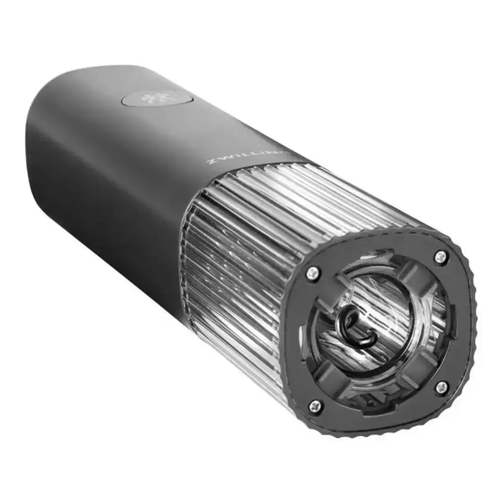 Black cylindrical device with metallic components on a white background