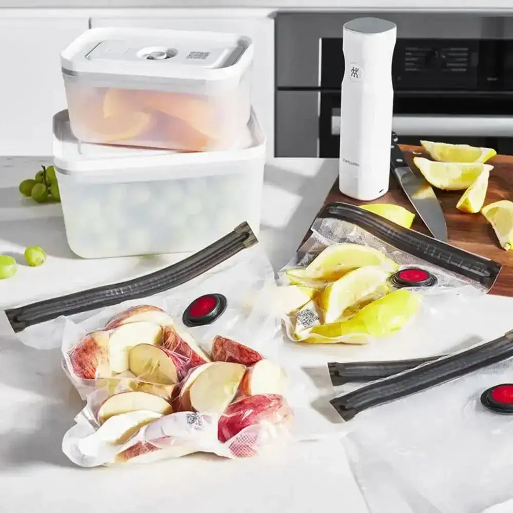 Food storage containers and vacuum sealers on a kitchen counter.