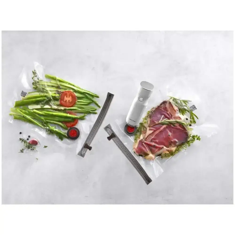 Vacuum sealer with food packaging on a white background