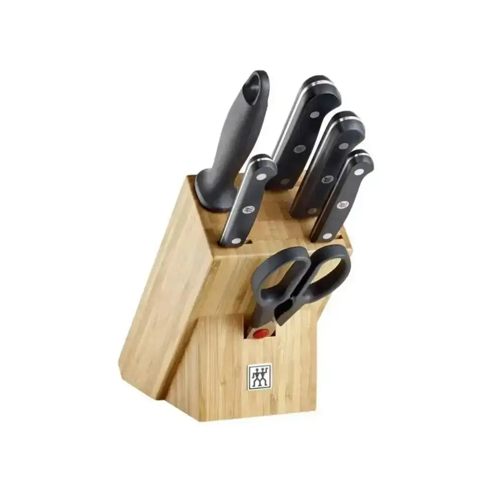 Set of knives and a pair of scissors in a wooden block on a white background