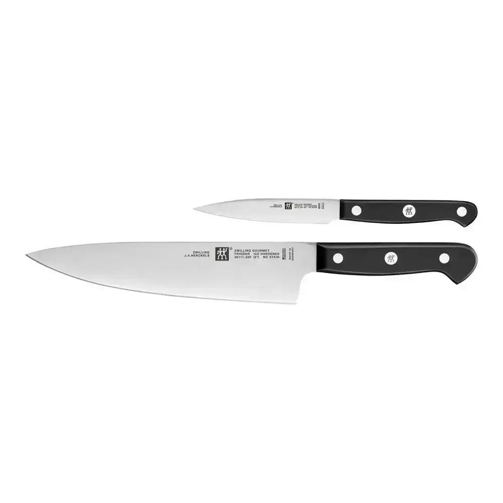 Two chef's knives with black handles on a white background