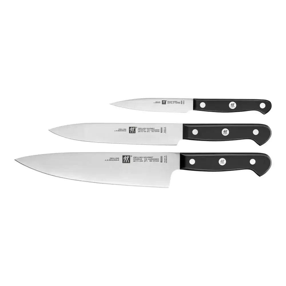 Set of three knives with black handles on a white background