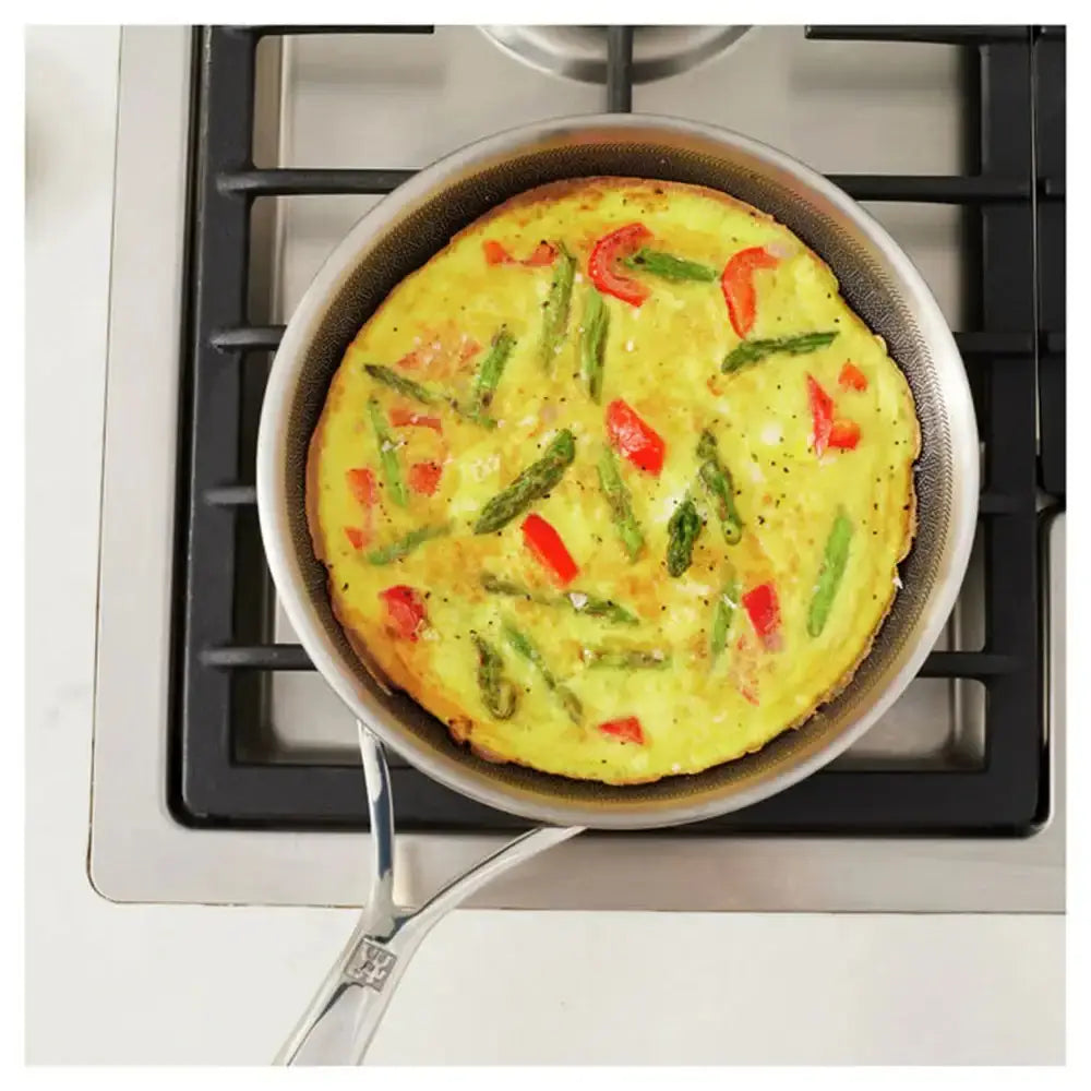 Vegetable frittata in a pan on a stovetop