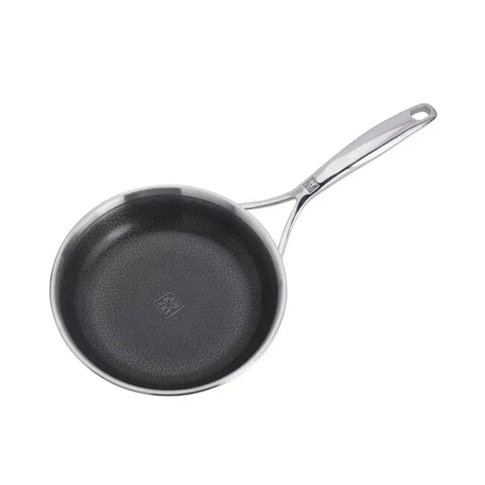 Stainless steel frying pan with a black interior on a white background