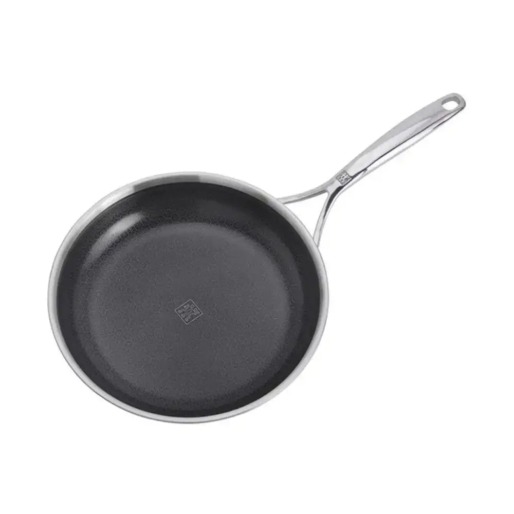 Black frying pan with a silver handle on a white background