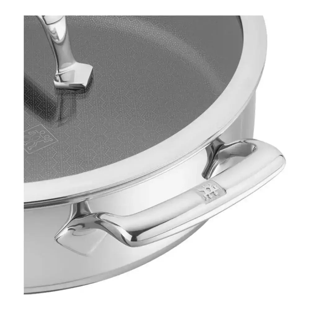 Close-up of a silver pot handle on a gray background