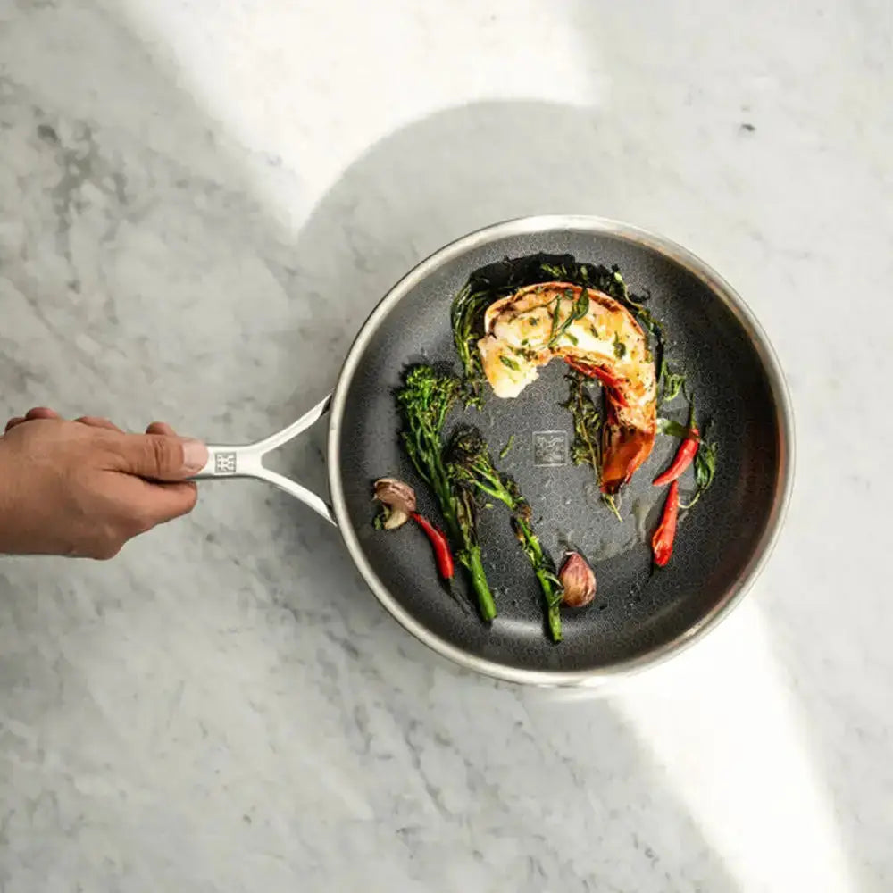 Frying pan with food on a marble surface