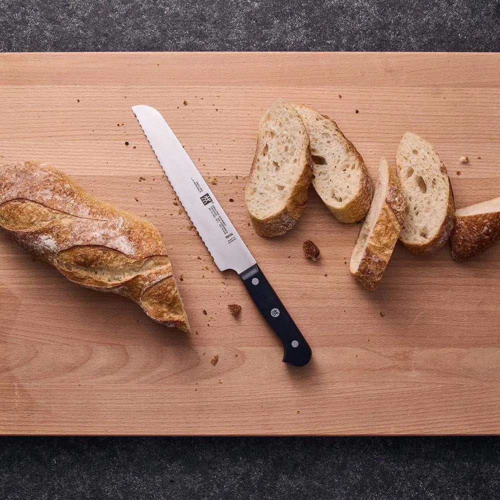 Sliced bread and a knife on a wooden cutting board