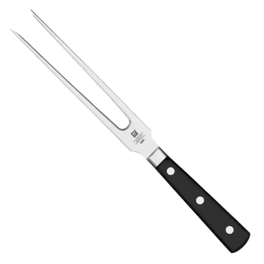 Metal meat fork with black handle on a white background