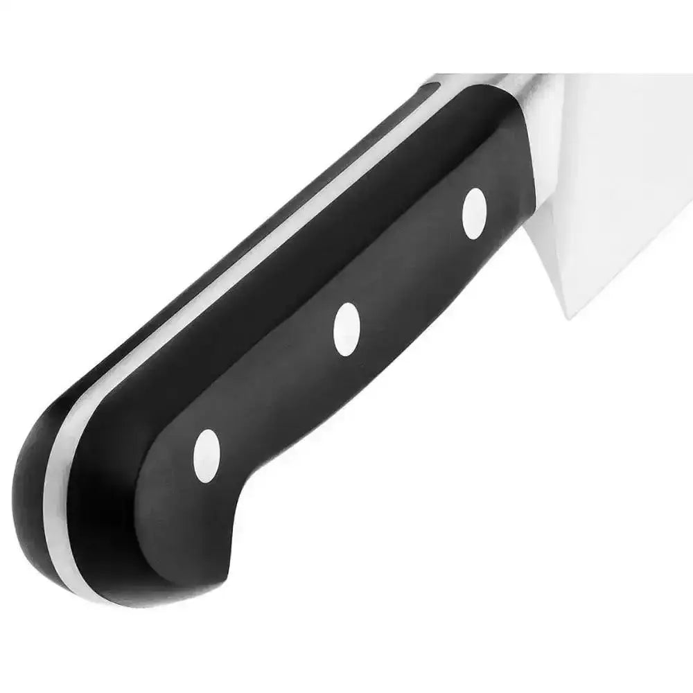 Close-up of a knife with a black handle on a white background