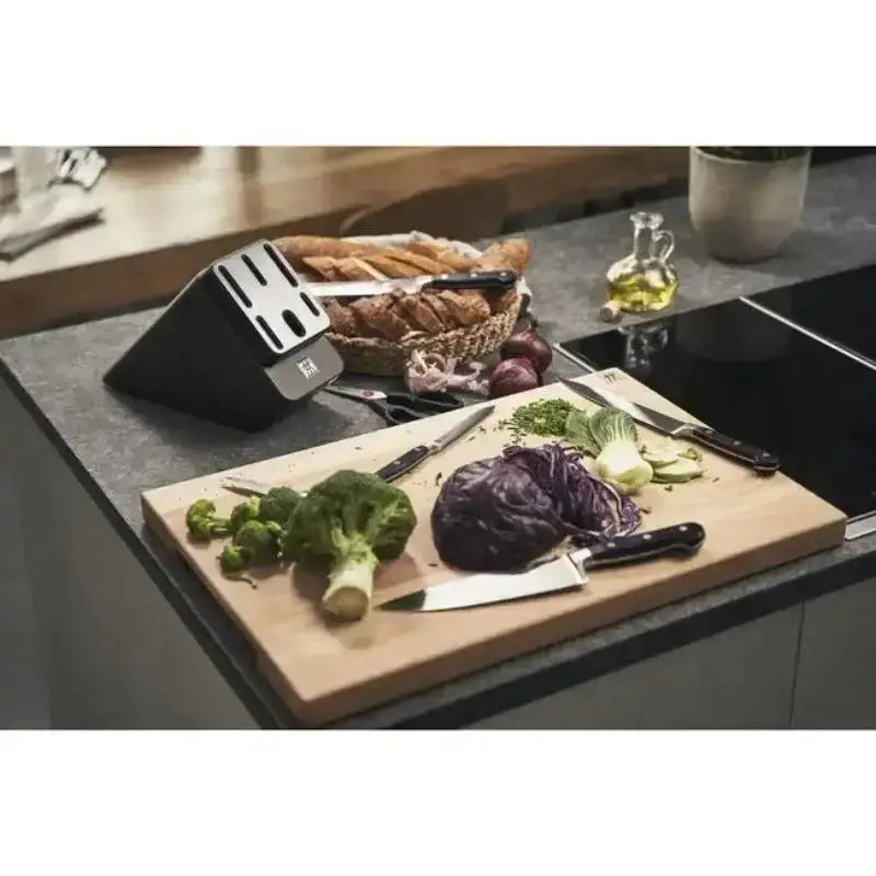 Kitchen counter with cutting board, vegetables, and a knife sharpener.