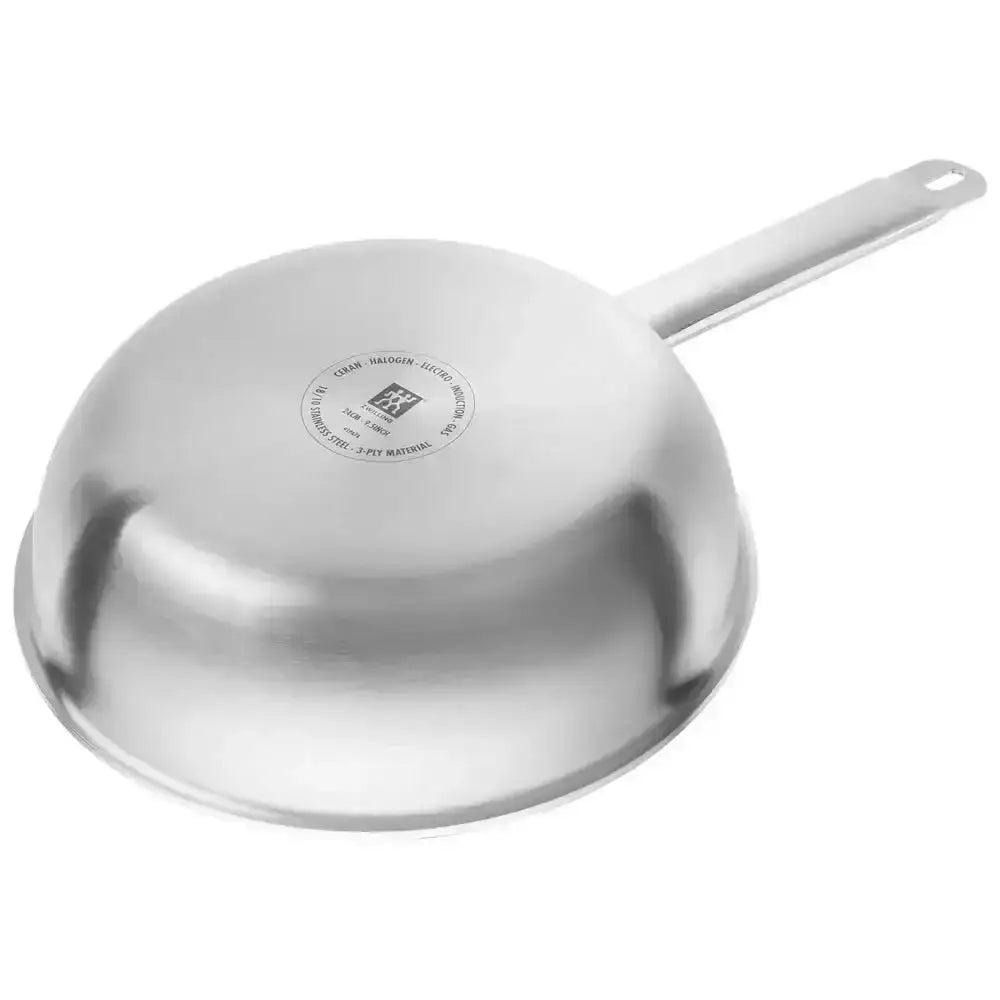 Stainless steel frying pan on a white background
