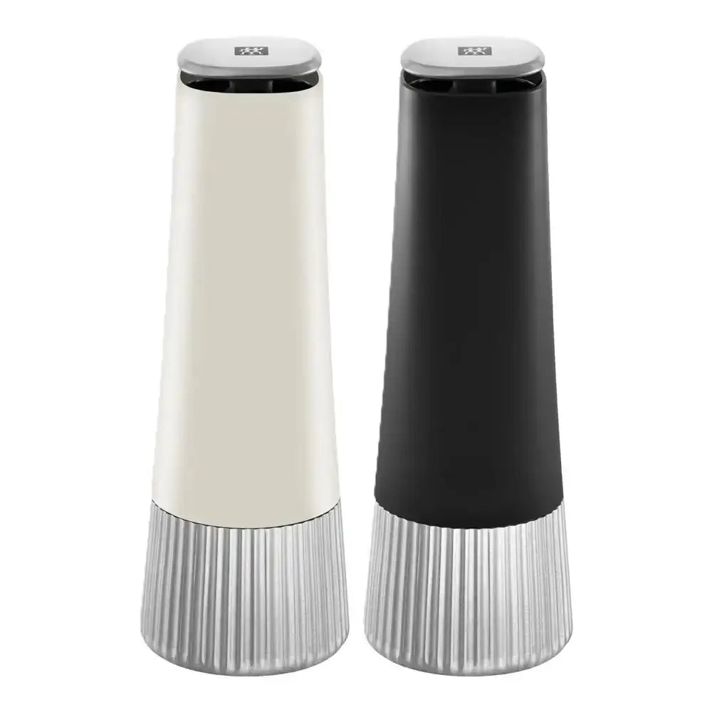 Two tall, cylindrical salt and pepper shakers in black and white on a white background.