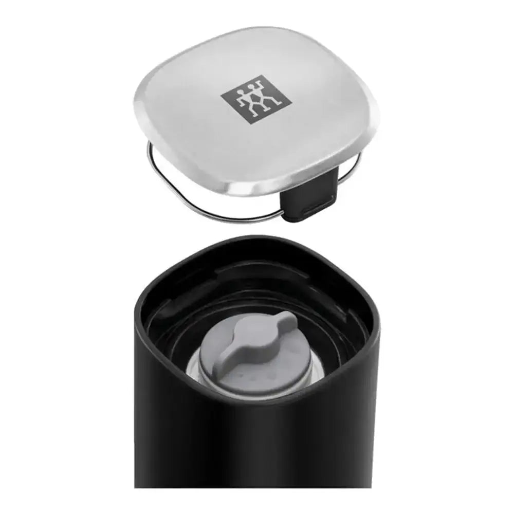 Black grinder with silver lid on a white background