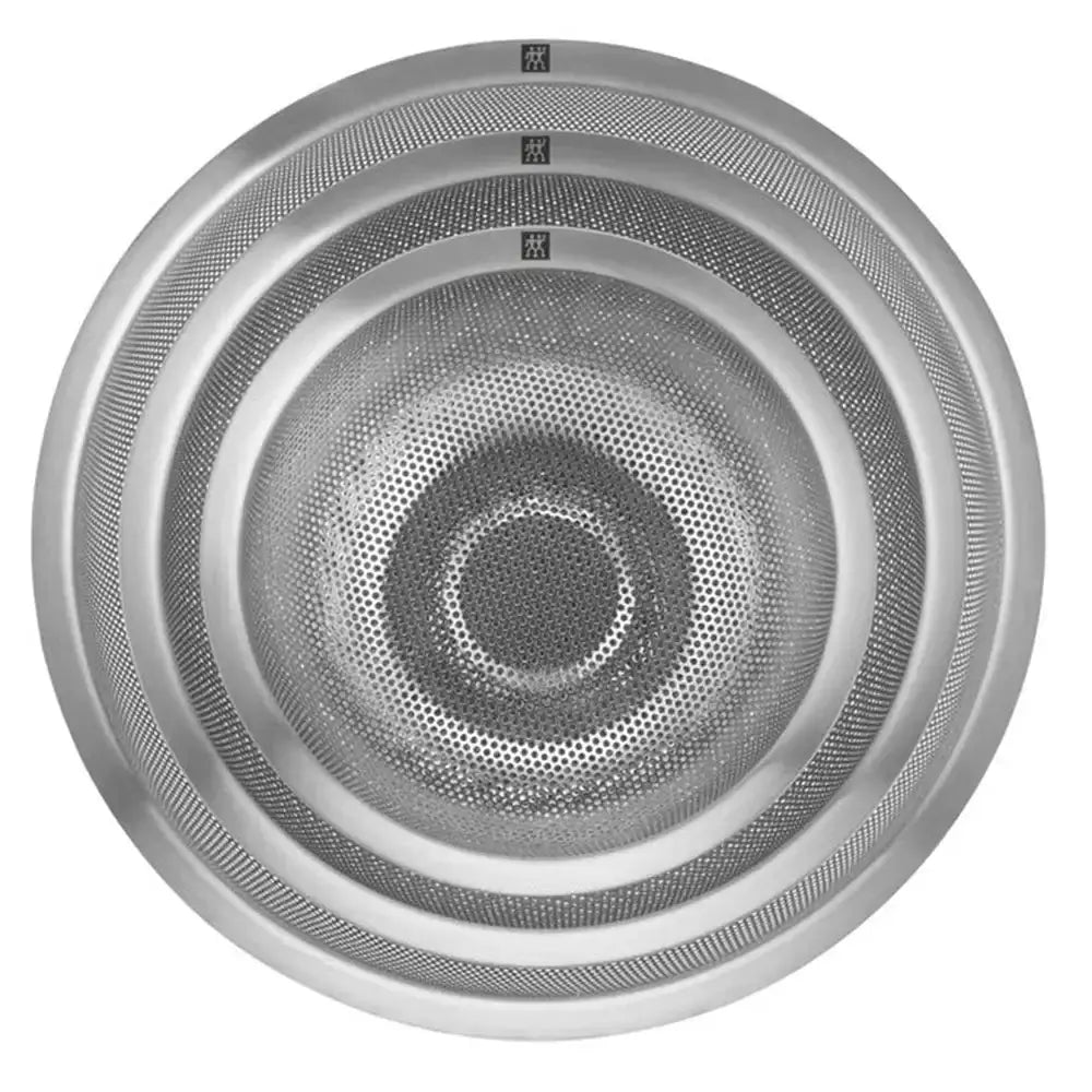 Round metallic colander with a grid pattern on a white background