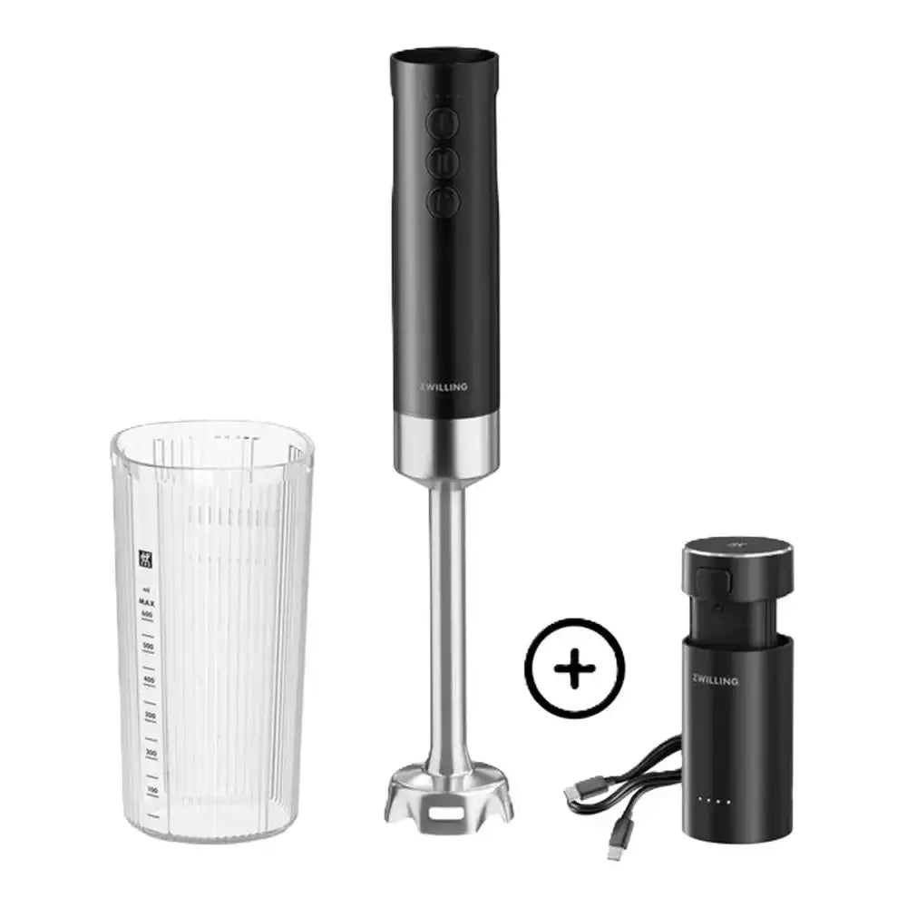 Black immersion blender set with measuring cup, attachment, and power base on a white background